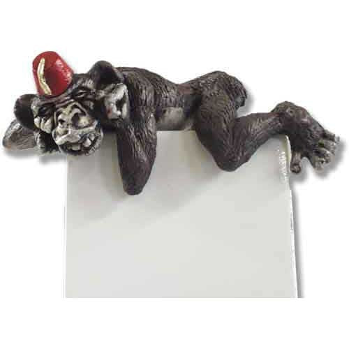 Whimsical old world European style monkey figurine wearing a fez, lounging playfully atop a flat surface with ornate detailing.