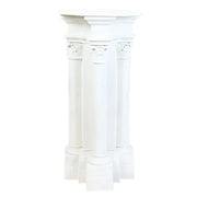 Classical Greek pedestal with three fluted columns, ornate Corinthian capitals, and intricate old world European detailing.