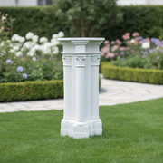 Classical Greek pedestal with three fluted columns, ornate Corinthian capitals, and intricate old world European detailing. Side Angle