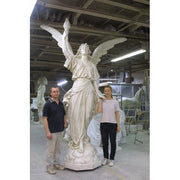 Winged angel statue in classical Renaissance style, holding a torch aloft, with flowing drapery and ornate detailing. Side View