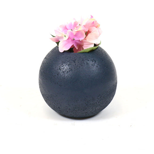Round, textured vase with a minimalist, old world European design and subtle, weathered surface reminiscent of classical pottery. Side Angle