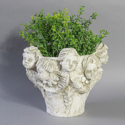 Ornate Baroque-style planter featuring sculpted cherub faces and classical old world European detailing around the rim. Side View