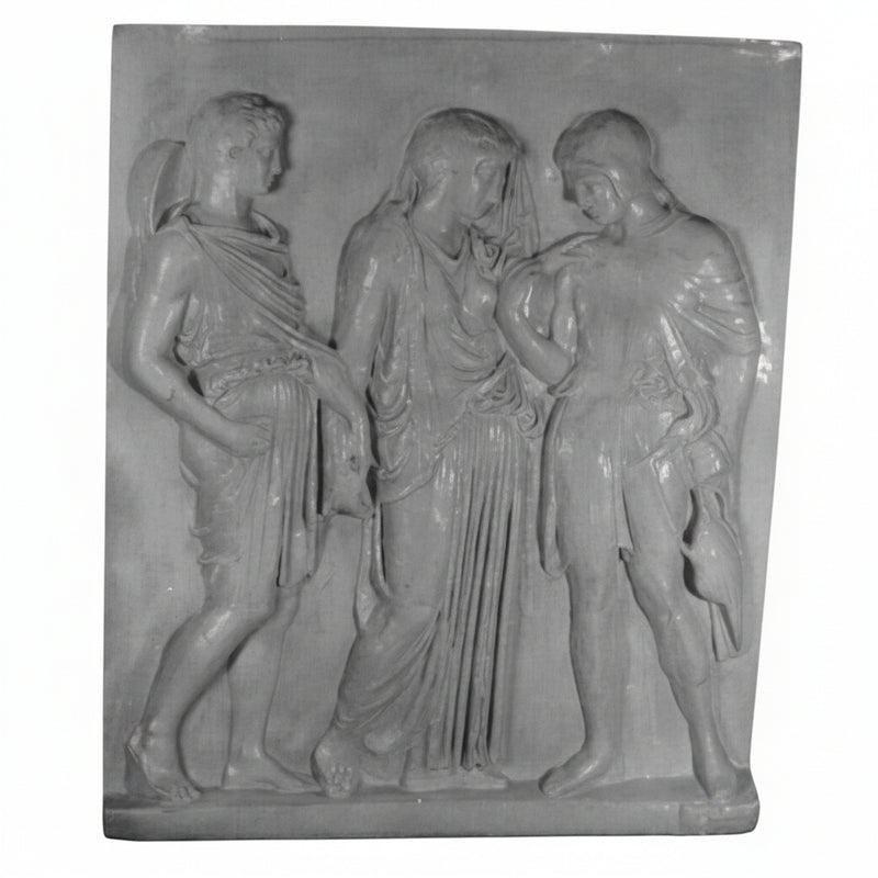 Classical Greek relief sculpture featuring three draped figures in flowing robes with detailed, ornate folds and ancient attire.
