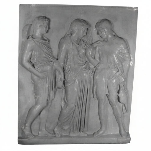 Classical Greek relief sculpture featuring three draped figures in flowing robes with detailed, ornate folds and ancient attire.