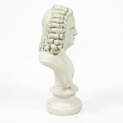 Classical European bust with ornate, curly hair in old world style, displayed on a pedestal with Renaissance-inspired detailing. Side Angle