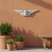Winged cherub face with ornate, detailed feathers in a classical Baroque style, evoking old world European architecture. Additional Angle
