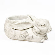 Rabbit-shaped planter with ornate floral motif, featuring old world European style and filled with yellow and orange flowers. Other Angle