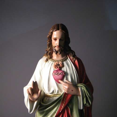 Sacred Heart of Jesus statue in classical Renaissance style, featuring ornate robes and detailed facial expression, standing on a pedestal. Side Angle View