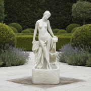 Classical Renaissance-style female statue with draped cloth, standing in a graceful pose on an ornate pedestal. Side Angle